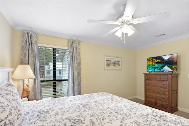 carpeted bedroom with ceiling fan and crown molding