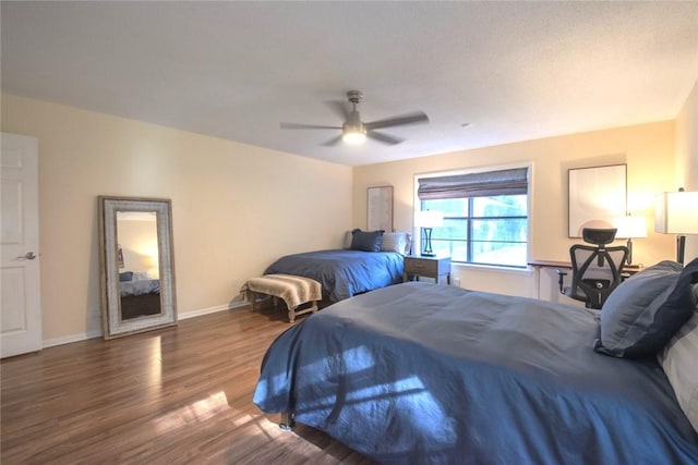 bedroom featuring wood finished floors, baseboards, and ceiling fan