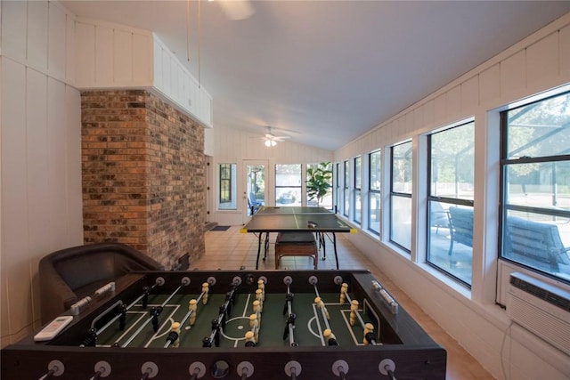 game room featuring lofted ceiling and a ceiling fan