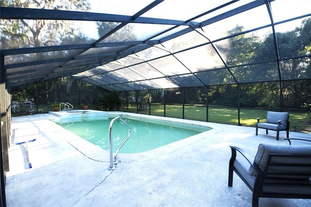 view of pool with glass enclosure, a yard, and a patio