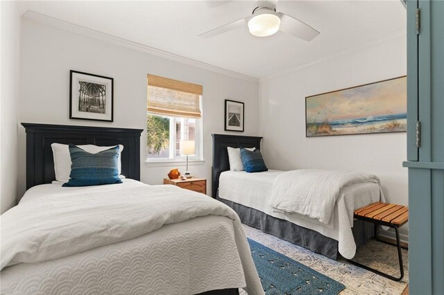 bedroom with ornamental molding, wood finished floors, and a ceiling fan