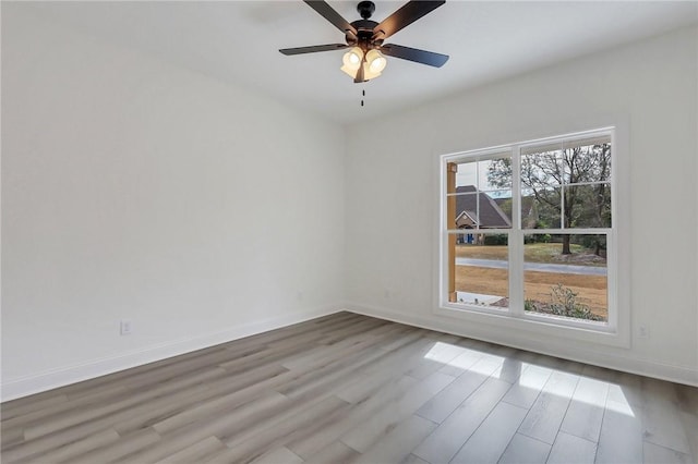 empty room featuring ceiling fan and light hardwood / wood-style flooring