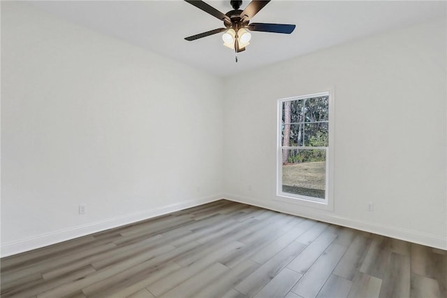 spare room with hardwood / wood-style floors and ceiling fan