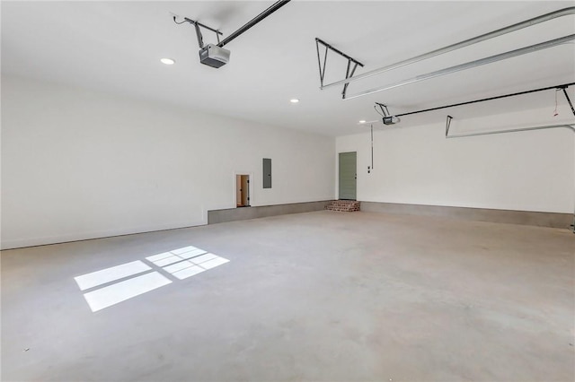 garage featuring electric panel and a garage door opener