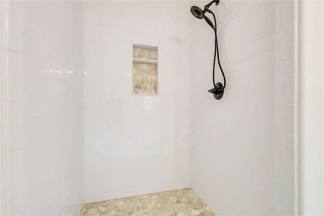 bathroom with a tile shower