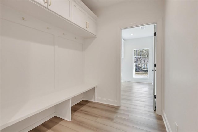 mudroom with light hardwood / wood-style floors