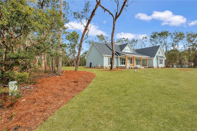 view of front of property featuring covered porch and a front lawn