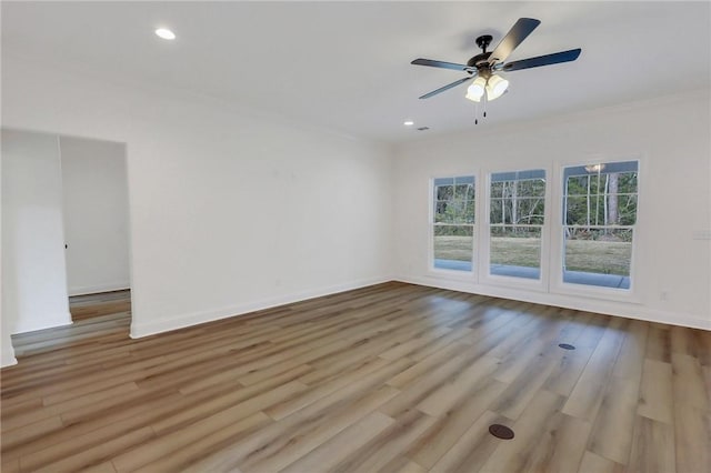 spare room with light hardwood / wood-style floors, ceiling fan, and ornamental molding