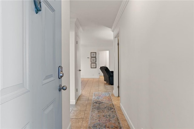 hall with crown molding and light tile patterned flooring