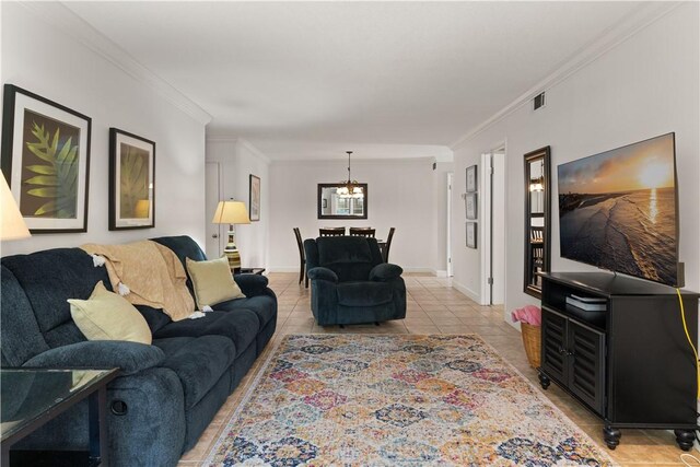 living room featuring light tile patterned floors, crown molding, and an inviting chandelier