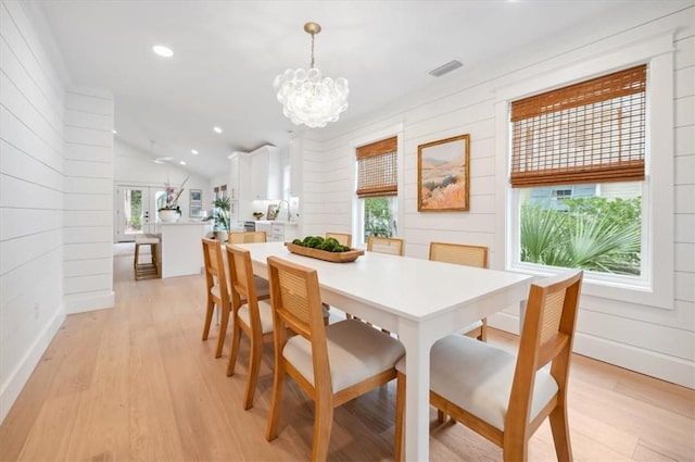 301 Kelsall Ave, Saint Simons Island, GA 31522 - dining area with light wood finished floors, lofted ceiling, a chandelier, recessed lighting, and wooden walls