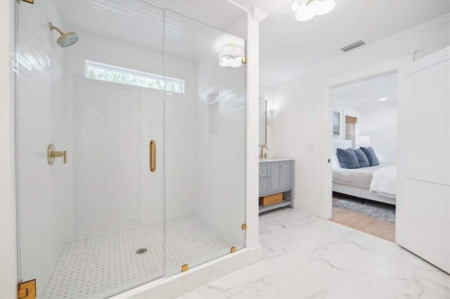 301 Kelsall Ave, Saint Simons Island, GA 31522 - bathroom featuring a stall shower, vanity, marble finish floors, ensuite bathroom, and crown molding