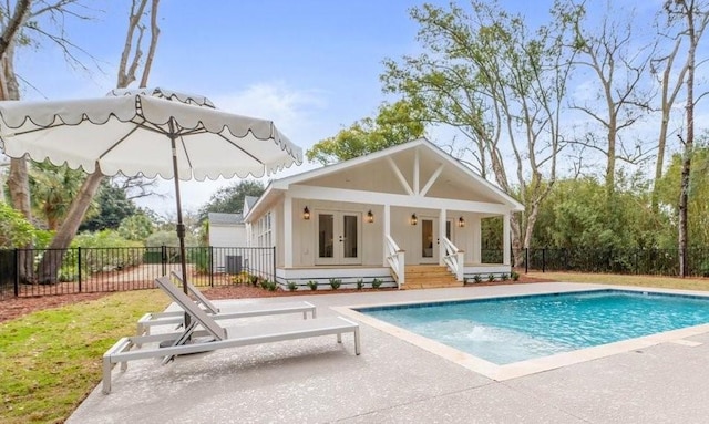 301 Kelsall Ave, Saint Simons Island, GA 31522 - back of property with french doors, a patio, and an outbuilding