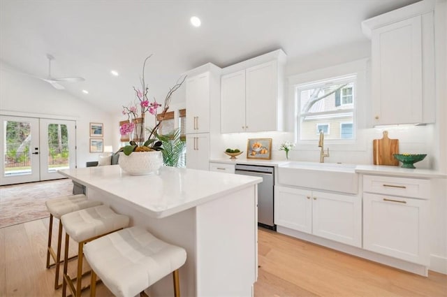 301 Kelsall Ave, Saint Simons Island, GA 31522 - kitchen with dishwasher, light wood-type flooring, plenty of natural light, recessed lighting, and vaulted ceiling