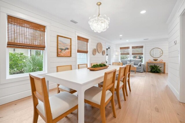 301 Kelsall Ave, Saint Simons Island, GA 31522 - dining space featuring plenty of natural light, light wood-style floors, a chandelier, recessed lighting, and wooden walls