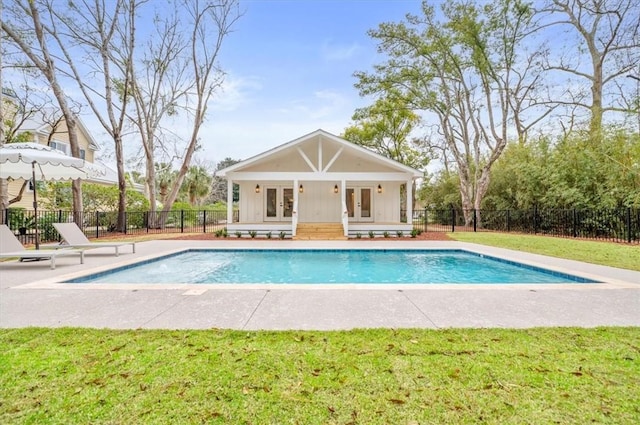 301 Kelsall Ave, Saint Simons Island, GA 31522 - view of swimming pool with french doors, an exterior structure, an outbuilding, and a patio