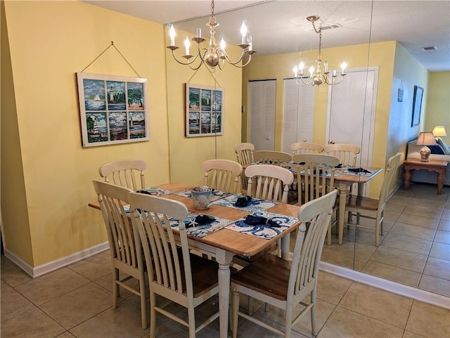 tiled dining room featuring an inviting chandelier