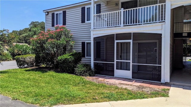 exterior space featuring a yard and a balcony