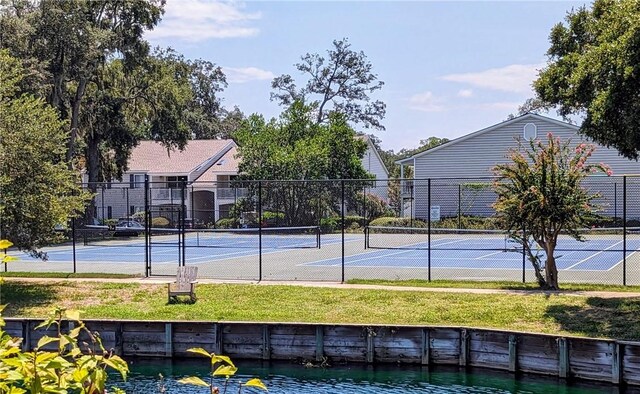 view of sport court featuring a yard