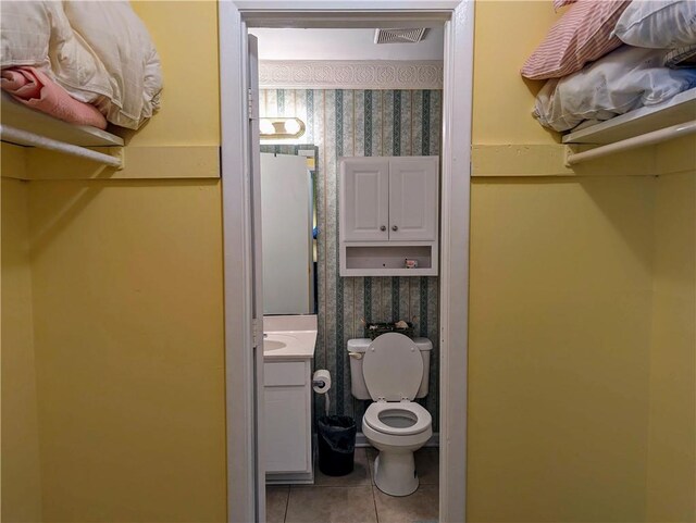 bathroom with tile patterned floors, vanity, and toilet