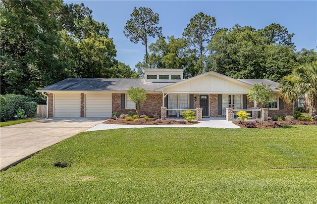 view of front facade with a front yard, a garage, and covered porch