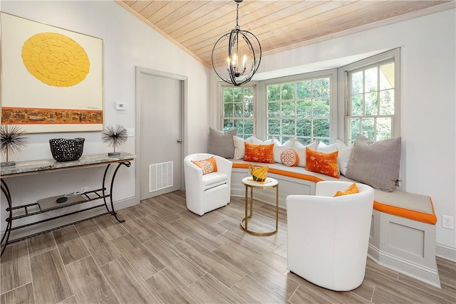 living area with a notable chandelier, vaulted ceiling, wooden ceiling, and breakfast area