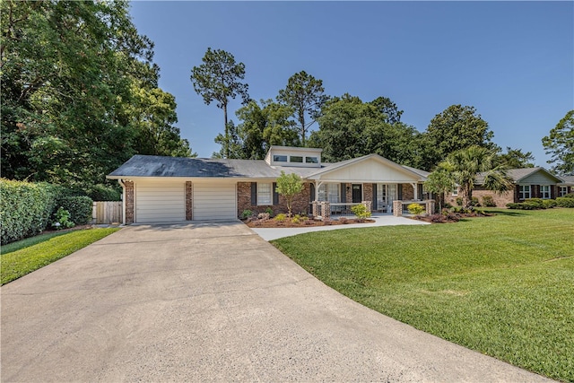 view of front of property with a front yard and a garage