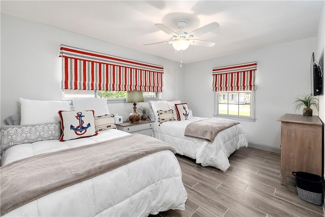 bedroom with multiple windows and ceiling fan