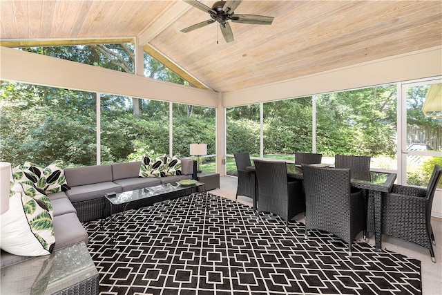 sunroom with lofted ceiling, a healthy amount of sunlight, ceiling fan, and wooden ceiling