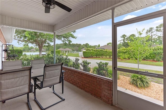 sunroom featuring a wealth of natural light, outdoor dining area, and a ceiling fan