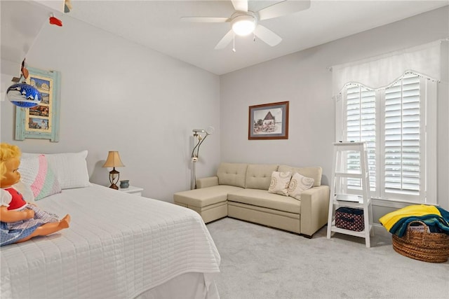bedroom with multiple windows, ceiling fan, and carpet floors