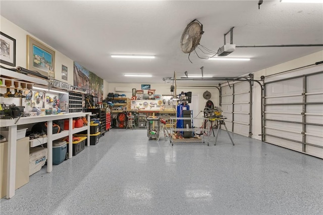 garage with a garage door opener and a workshop area