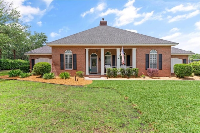 view of front facade featuring a front lawn, a garage, a chimney, covered porch, and brick siding