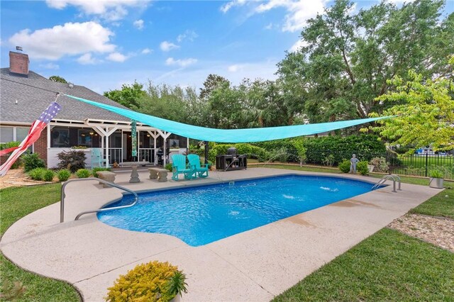 view of swimming pool featuring a patio, a fenced in pool, and fence