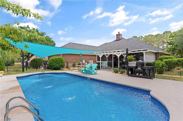 view of swimming pool featuring fence, a patio area, and a fenced in pool