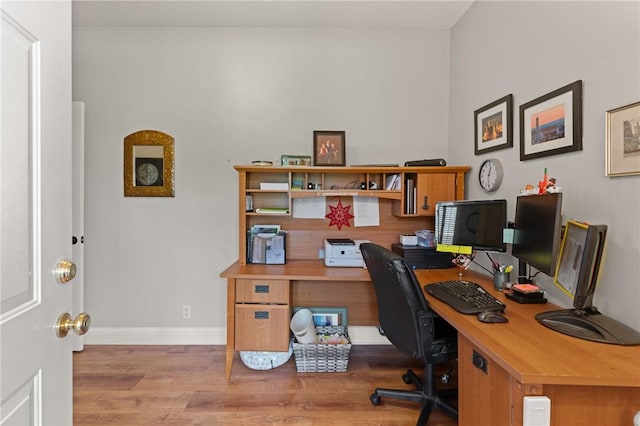 office area with wood finished floors and baseboards