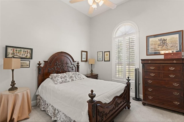 bedroom featuring ceiling fan, baseboards, high vaulted ceiling, and light carpet