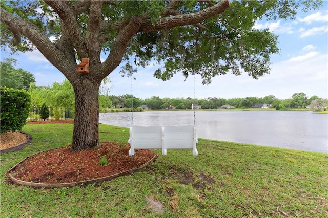 view of yard with fence and a water view