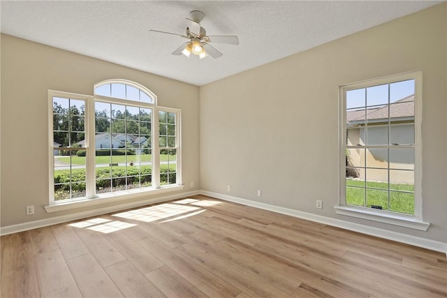 223 Edge Water Dr, Brunswick, GA 31525 - empty room with wood finished floors, baseboards, ceiling fan, and a textured ceiling