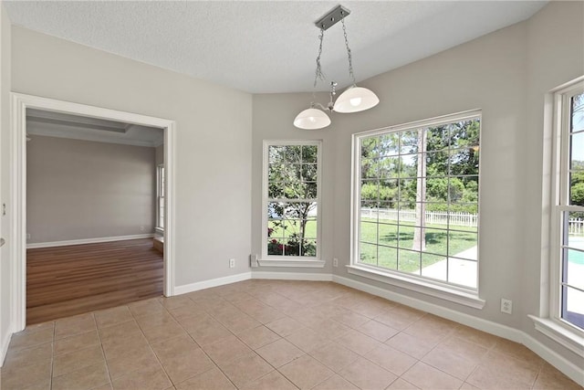 223 Edge Water Dr, Brunswick, GA 31525 - unfurnished dining area featuring light tile patterned flooring, a textured ceiling, and baseboards