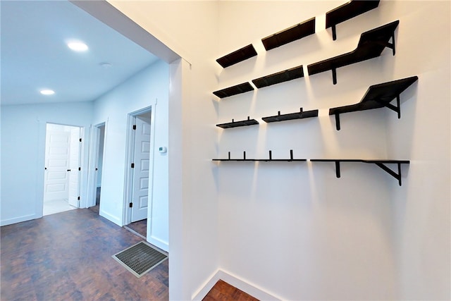 hall featuring lofted ceiling and dark hardwood / wood-style floors