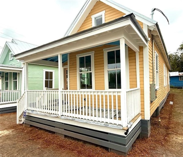 back of property with covered porch