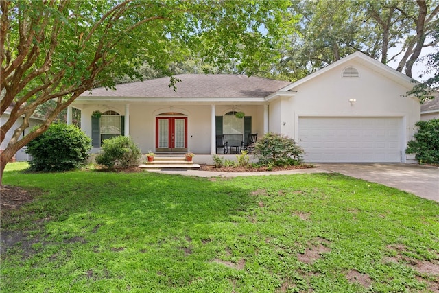 104 Ashwood Way, Saint Simons Island, GA 31522 - ranch-style home featuring french doors, concrete driveway, stucco siding, a front yard, and a garage