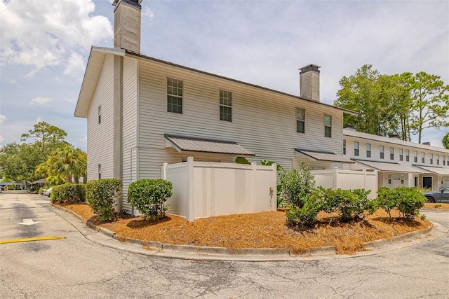 132 S Island Square Dr, Saint Simons Island, GA 31522 - back of house with a chimney