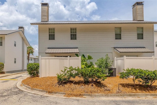 132 S Island Square Dr, Saint Simons Island, GA 31522 - view of front of property featuring a chimney and a metal roof