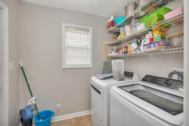 132 S Island Square Dr, Saint Simons Island, GA 31522 - laundry room featuring separate washer and dryer, tile patterned flooring, and a textured ceiling