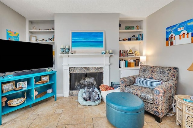 132 S Island Square Dr, Saint Simons Island, GA 31522 - sitting room with built in shelves, a fireplace, and a textured ceiling