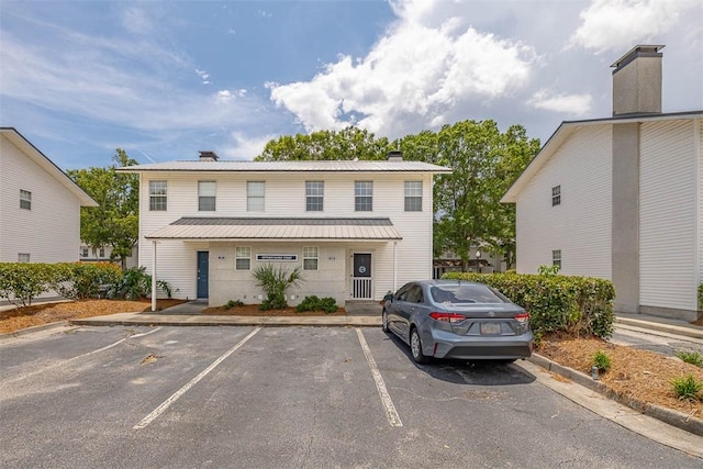 132 S Island Square Dr, Saint Simons Island, GA 31522 - multi unit property with uncovered parking, a chimney, and a metal roof