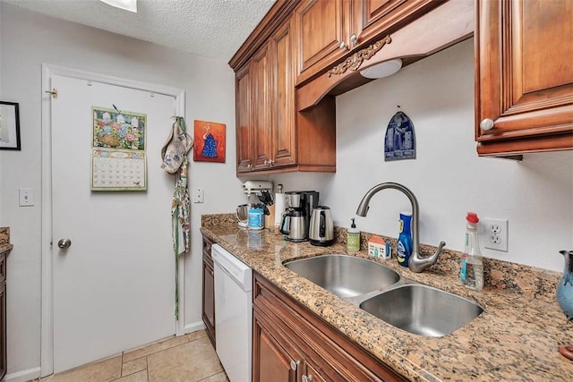 132 S Island Square Dr, Saint Simons Island, GA 31522 - kitchen with dishwasher, brown cabinetry, light stone counters, and a textured ceiling