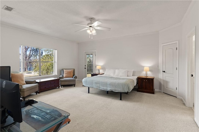 carpeted bedroom with crown molding and ceiling fan